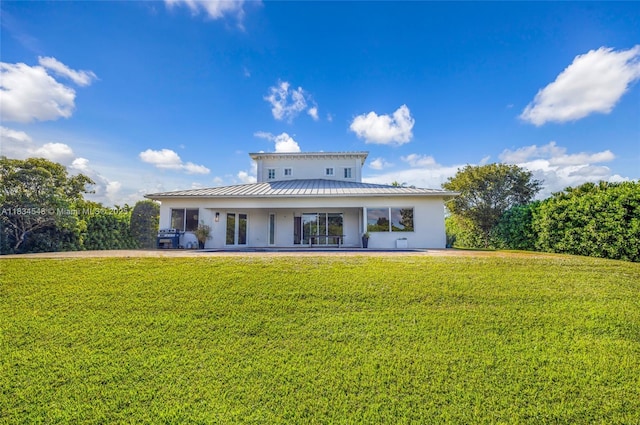 16701 SW 49th St, Southwest Ranches, FL 33331 - back of property with stucco siding, a yard, a metal roof, and a standing seam roof