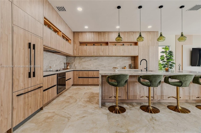 18269 SW 54th St, Miramar, FL 33029 - kitchen featuring modern cabinets, black appliances, light brown cabinetry, a breakfast bar area, and recessed lighting