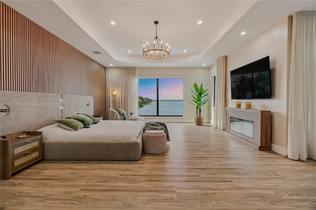 18269 SW 54th St, Miramar, FL 33029 - bedroom with a chandelier, wood finished floors, access to outside, a glass covered fireplace, and recessed lighting