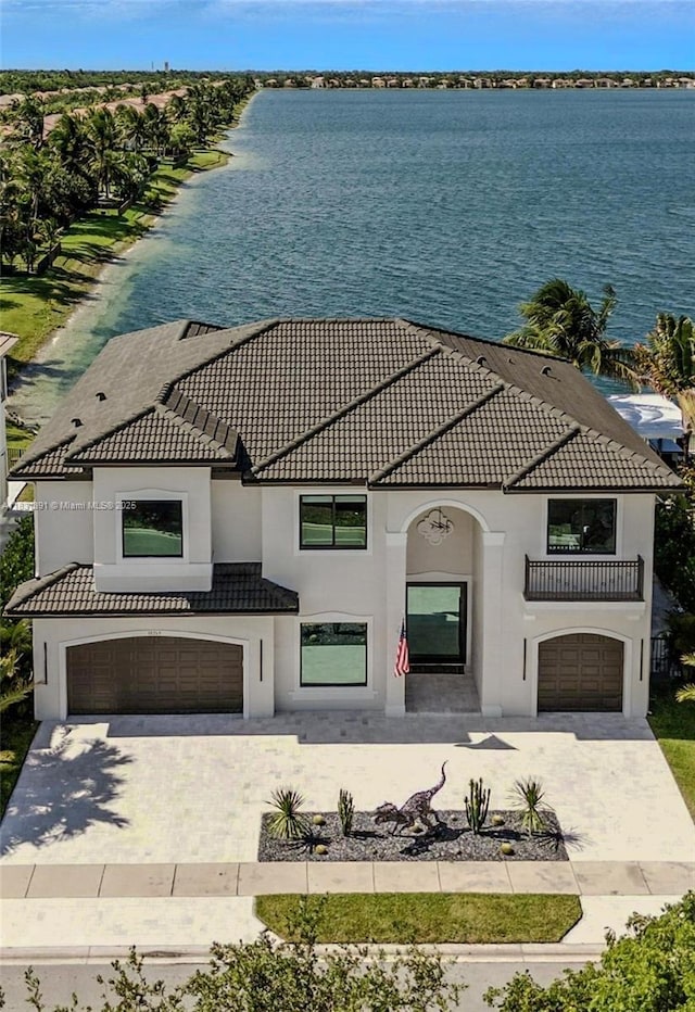 18269 SW 54th St, Miramar, FL 33029 - view of front of house featuring a tile roof, a water view, an attached garage, driveway, and stucco siding