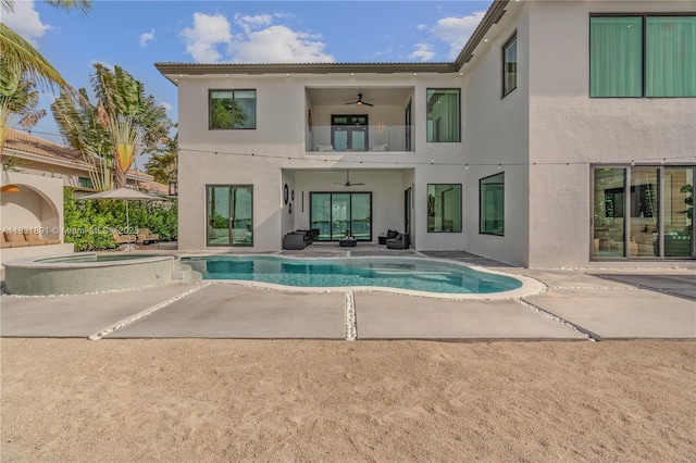18269 SW 54th St, Miramar, FL 33029 - back of property with a balcony, an in-ground hot tub, stucco siding, a ceiling fan, and a patio area
