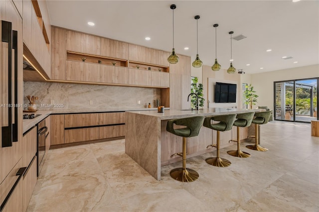 18269 SW 54th St, Miramar, FL 33029 - kitchen featuring modern cabinets, light brown cabinets, backsplash, a kitchen bar, and recessed lighting