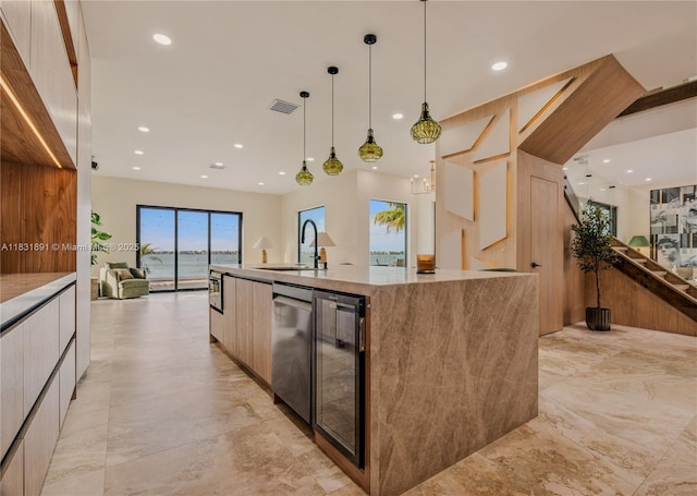 18269 SW 54th St, Miramar, FL 33029 - kitchen with modern cabinets, wine cooler, a large island with sink, open floor plan, and stainless steel dishwasher