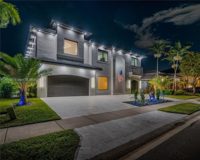 18269 SW 54th St, Miramar, FL 33029 - view of front of house with an attached garage, stucco siding, a tile roof, decorative driveway, and a balcony