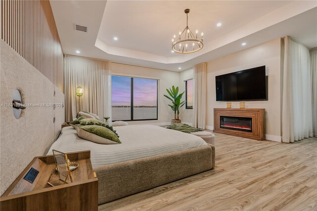 18269 SW 54th St, Miramar, FL 33029 - bedroom featuring recessed lighting, wood finished floors, a raised ceiling, a chandelier, and a glass covered fireplace