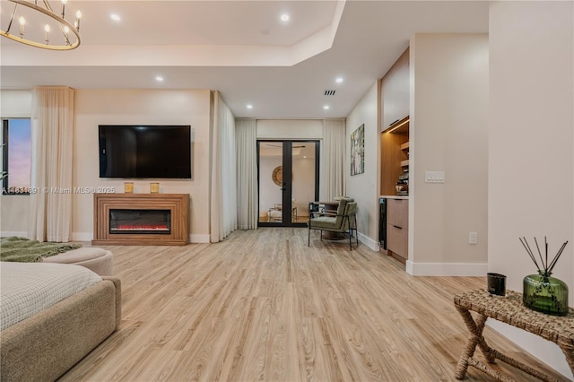 18269 SW 54th St, Miramar, FL 33029 - living room with light wood-style floors, recessed lighting, a glass covered fireplace, a chandelier, and french doors