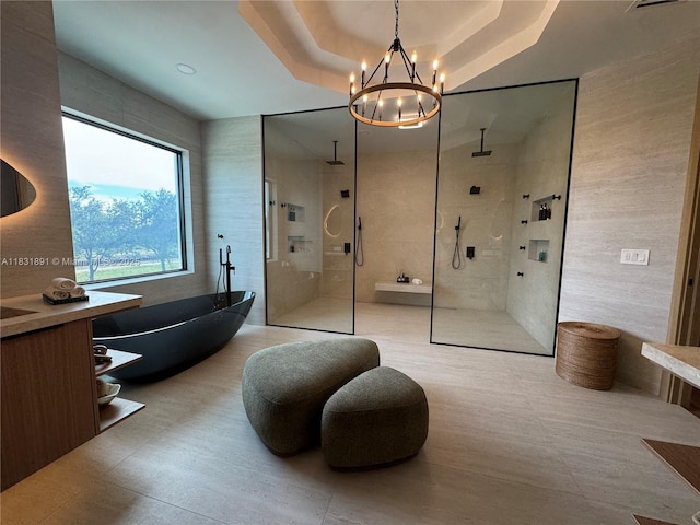 18269 SW 54th St, Miramar, FL 33029 - bathroom with a freestanding tub, walk in shower, a chandelier, tile walls, and vanity