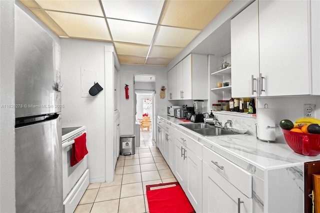 1430 NE 148th St, Miami, FL 33161 - kitchen featuring freestanding refrigerator, white range with electric stovetop, open shelves, light tile patterned floors, and white cabinets