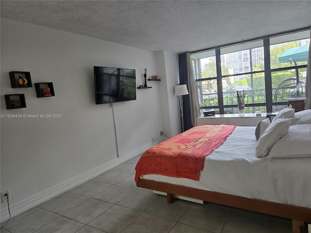 1000 Parkview Dr Unit 114, Hallandale Beach, FL 33009 - tiled bedroom featuring baseboards and a textured ceiling