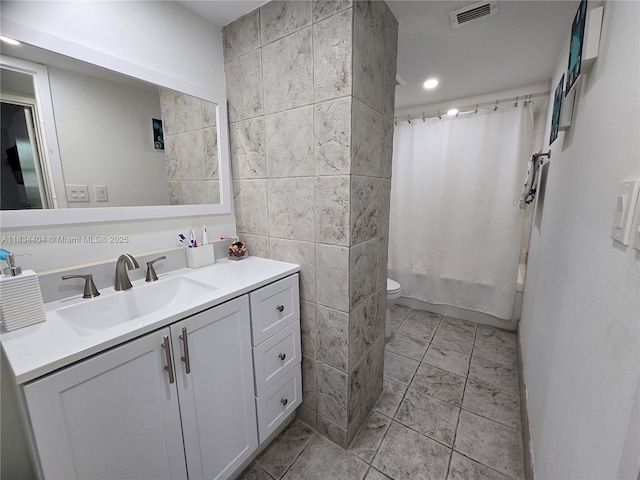 1000 Parkview Dr Unit 114, Hallandale Beach, FL 33009 - bathroom featuring tile walls, vanity, and shower / bath combo