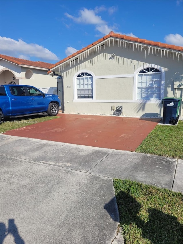 16909 SW 141st Ct, Miami, FL 33177 - view of side of property with stucco siding and a tile roof