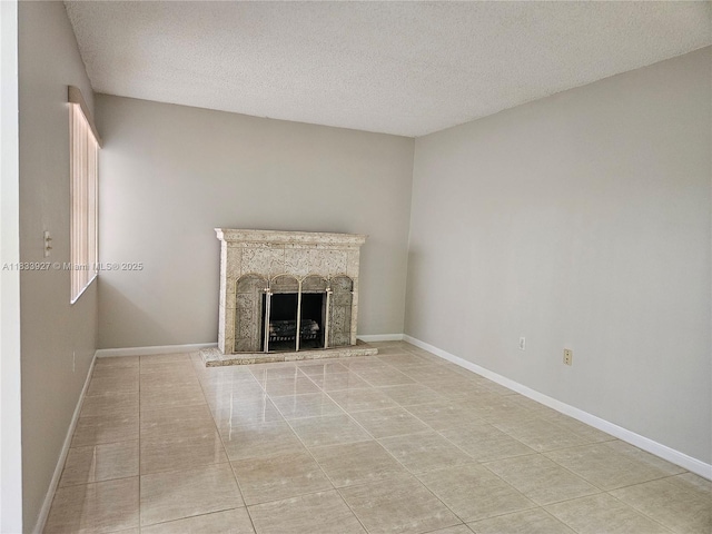9199 Fontainebleau Blvd Unit 6, Miami, FL 33172 - unfurnished living room with a textured ceiling, a fireplace with raised hearth, and tile patterned flooring