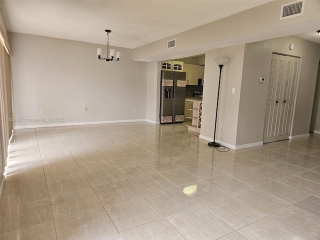 9199 Fontainebleau Blvd Unit 6, Miami, FL 33172 - unfurnished room with a textured ceiling, a chandelier, and light tile patterned flooring