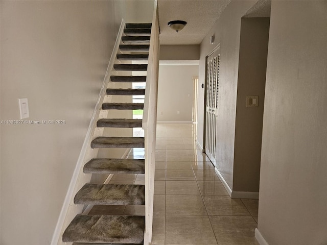 9199 Fontainebleau Blvd Unit 6, Miami, FL 33172 - stairs with tile patterned flooring and a textured ceiling