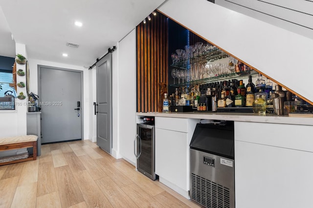 4000 NE 168th St Unit 113B, North Miami Beach, FL 33160 - indoor dry bar with wine cooler, light wood-type flooring, a barn door, and recessed lighting