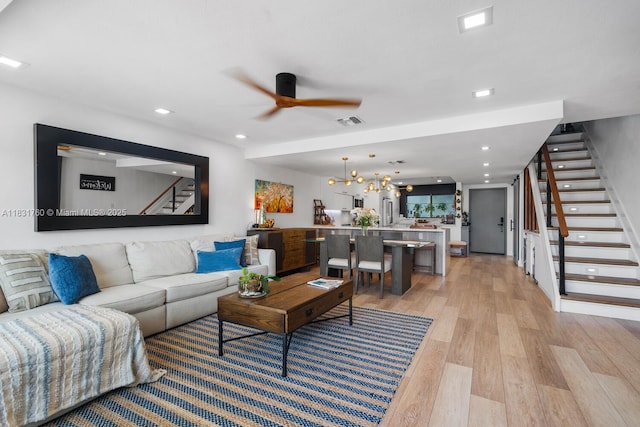 4000 NE 168th St Unit 113B, North Miami Beach, FL 33160 - living room featuring stairs, ceiling fan, light wood finished floors, a chandelier, and recessed lighting
