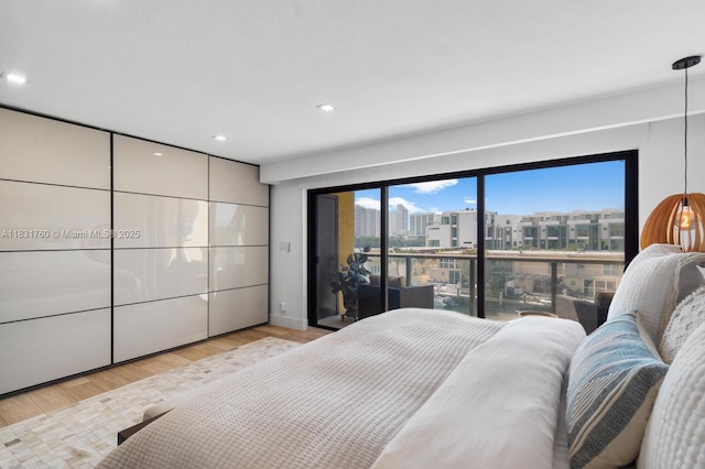 4000 NE 168th St Unit 113B, North Miami Beach, FL 33160 - bedroom with wood finished floors and recessed lighting
