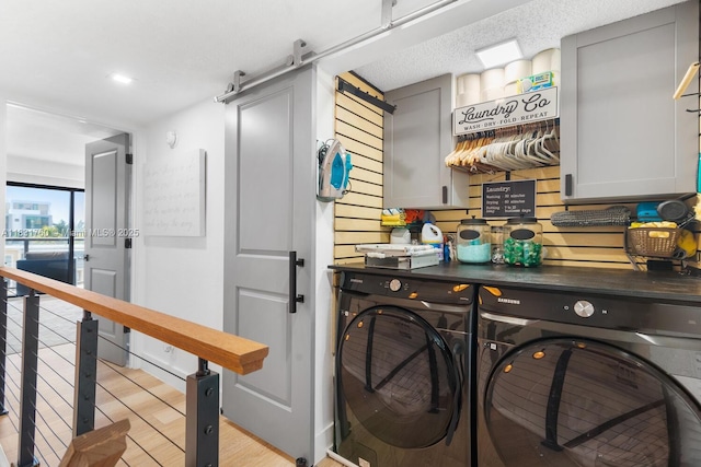 4000 NE 168th St Unit 113B, North Miami Beach, FL 33160 - laundry area featuring washer and clothes dryer, cabinet space, and a barn door