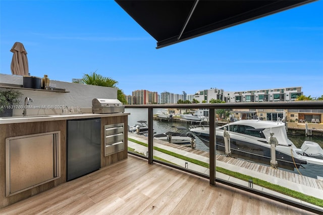 4000 NE 168th St Unit 113B, North Miami Beach, FL 33160 - balcony with a water view, exterior kitchen, and a dock