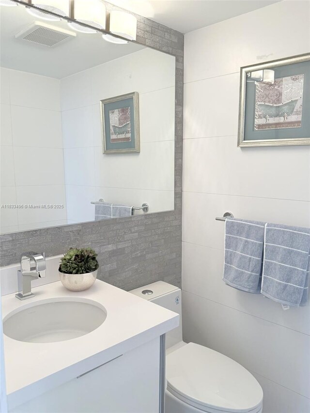 10275 Collins Ave Unit 722, Bal Harbour, FL 33154 - bathroom with vanity and tile walls