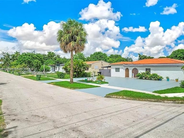 1385 NE 130th St, North Miami, FL 33161 - mediterranean / spanish-style house with driveway, stucco siding, and a tile roof