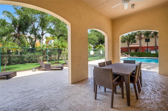 3335 Palomino Dr, Davie, FL 33024 - fenced backyard featuring ceiling fan, a patio area, a community pool, and outdoor dining area