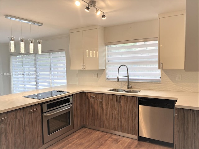 9017 SW 157th Path, Miami, FL 33196 - kitchen with appliances with stainless steel finishes, white cabinetry, light countertops, backsplash, and light wood-type flooring