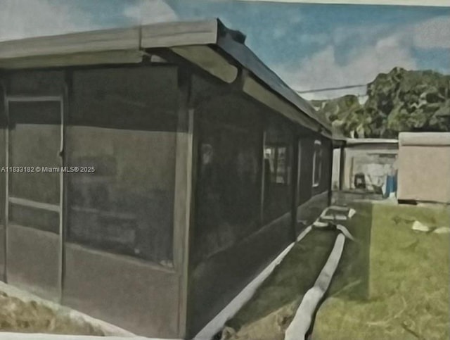 12625 NW 1st Ct, North Miami, FL 33168 - view of side of home featuring a sunroom