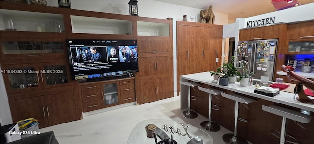 19185 SW 25th Ct, Miramar, FL 33029 - kitchen featuring stainless steel fridge, light countertops, and brown cabinets