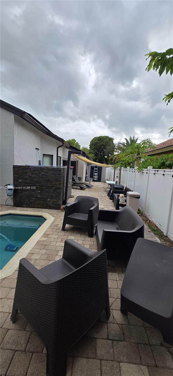 19185 SW 25th Ct, Miramar, FL 33029 - fenced backyard featuring outdoor lounge area and a patio