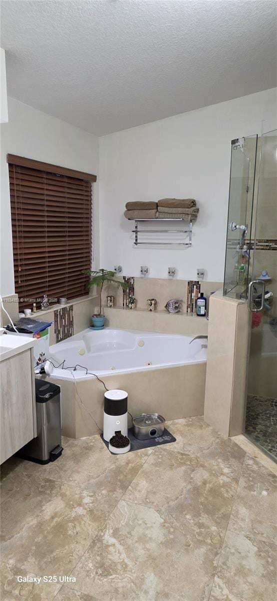 19185 SW 25th Ct, Miramar, FL 33029 - bathroom with a jetted tub, a shower stall, a textured ceiling, and vanity