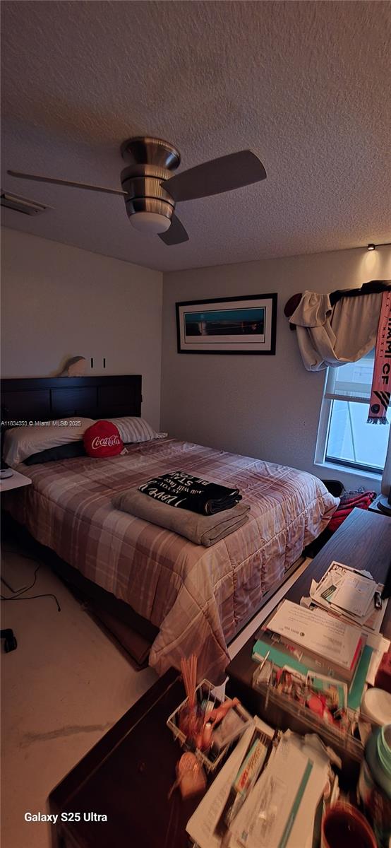19185 SW 25th Ct, Miramar, FL 33029 - bedroom with a textured ceiling and ceiling fan