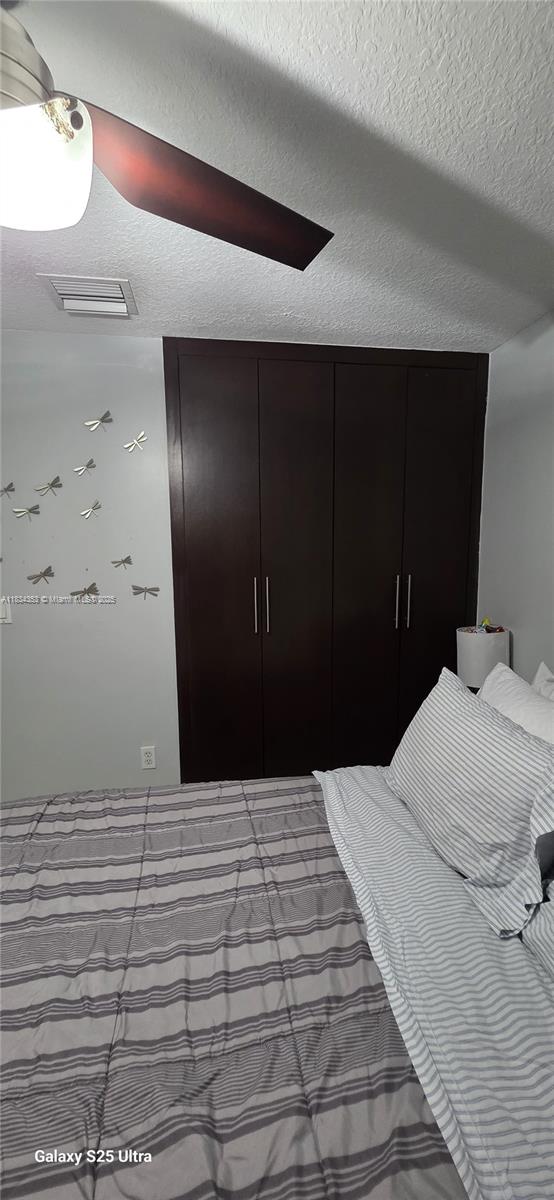 19185 SW 25th Ct, Miramar, FL 33029 - bedroom with a textured ceiling and a ceiling fan