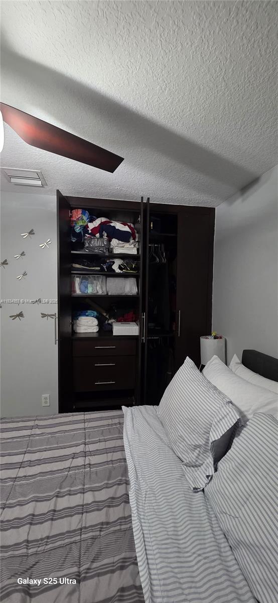 19185 SW 25th Ct, Miramar, FL 33029 - bedroom with a textured ceiling and ceiling fan