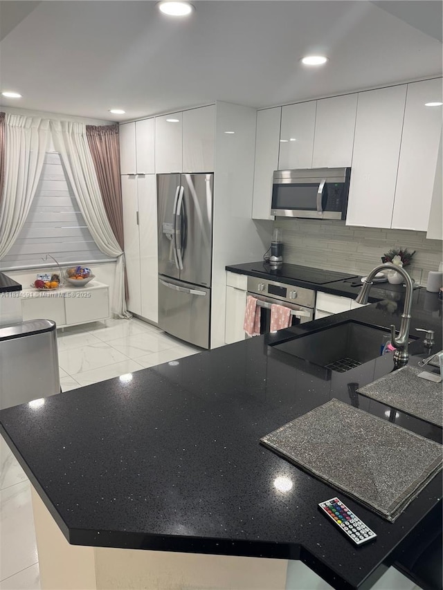 13355 SW 16th Ct Unit 105E, Pembroke Pines, FL 33027 - kitchen with appliances with stainless steel finishes, white cabinets, modern cabinets, backsplash, and recessed lighting