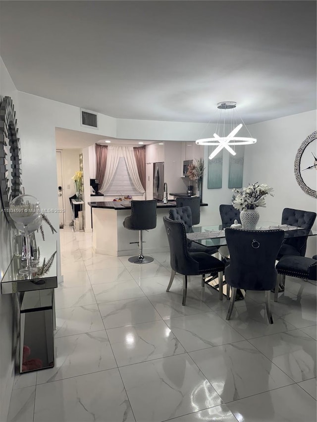 13355 SW 16th Ct Unit 105E, Pembroke Pines, FL 33027 - dining space with a chandelier and light marble finish floors