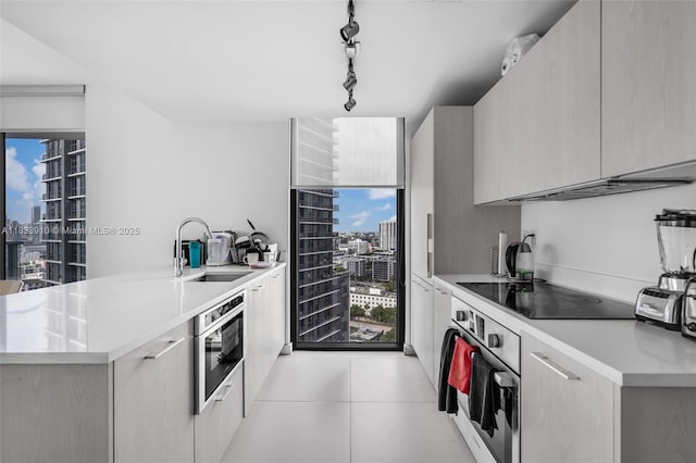 501 NE 31st St Unit 2308, Miami, FL 33137 - kitchen with stainless steel oven, a view of city, modern cabinets, and light countertops