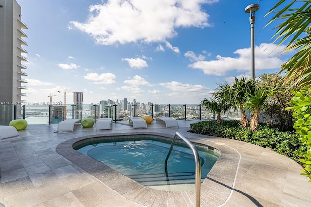 501 NE 31st St Unit 2308, Miami, FL 33137 - view of swimming pool featuring a view of skyline, a community hot tub, a pool, and a patio