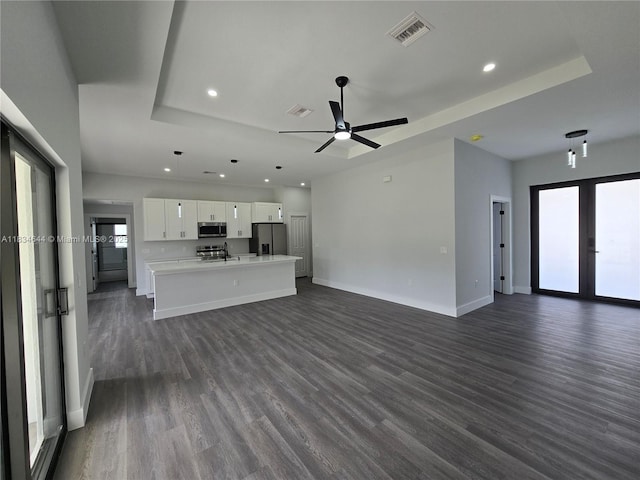 1605 W 11th St, Lehigh Acres, FL 33971 - unfurnished living room featuring recessed lighting, a tray ceiling, dark wood finished floors, and a ceiling fan
