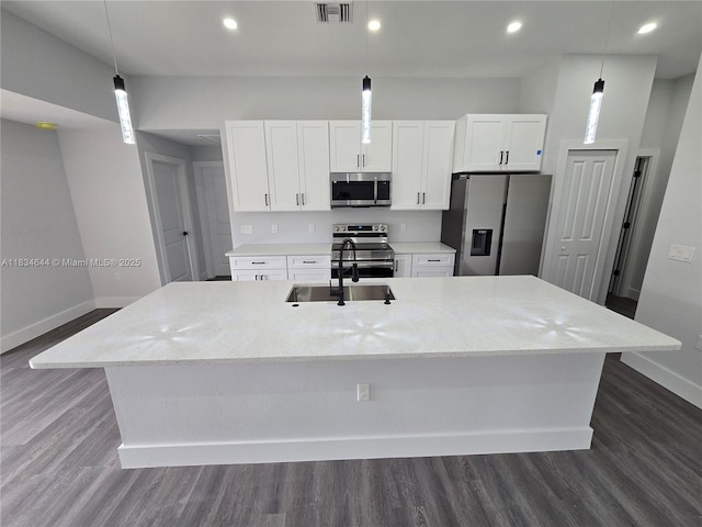 1605 W 11th St, Lehigh Acres, FL 33971 - kitchen featuring stainless steel appliances, a large island, white cabinetry, dark wood-style flooring, and recessed lighting