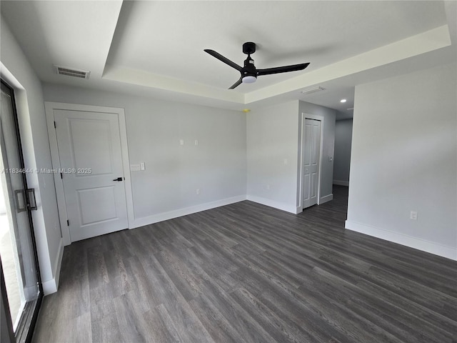 1605 W 11th St, Lehigh Acres, FL 33971 - empty room with a tray ceiling, ceiling fan, dark wood finished floors, and recessed lighting
