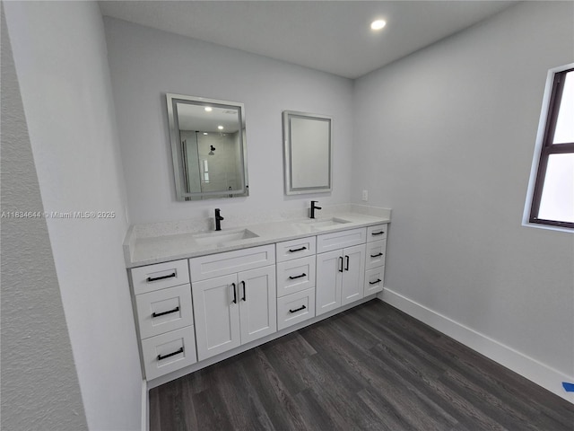 1605 W 11th St, Lehigh Acres, FL 33971 - full bathroom with a stall shower, wood finished floors, double vanity, and recessed lighting