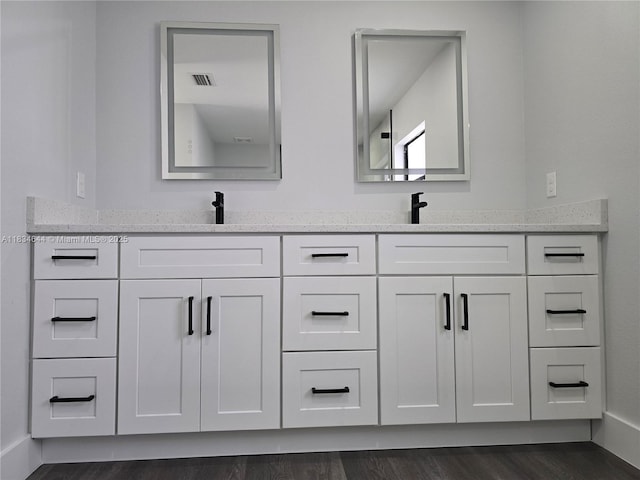 1605 W 11th St, Lehigh Acres, FL 33971 - bathroom featuring double vanity and wood finished floors