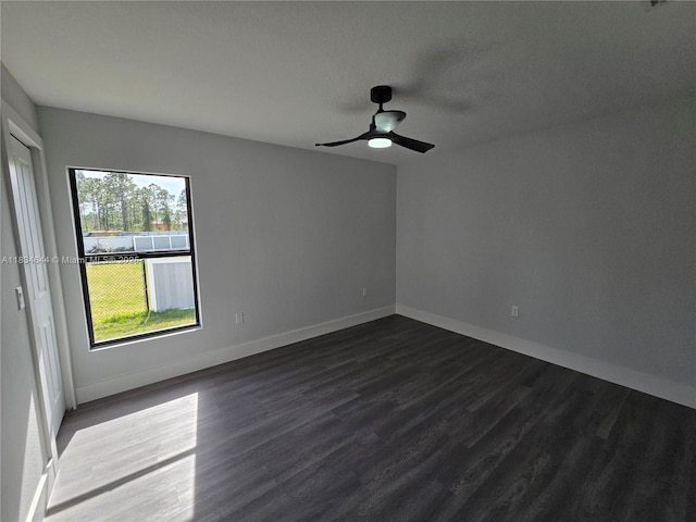 1605 W 11th St, Lehigh Acres, FL 33971 - spare room featuring dark wood-type flooring and ceiling fan