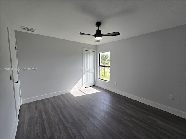 1605 W 11th St, Lehigh Acres, FL 33971 - empty room featuring dark wood-style flooring and a ceiling fan