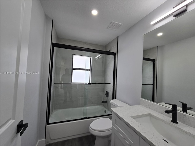 1605 W 11th St, Lehigh Acres, FL 33971 - bathroom featuring vanity, enclosed tub / shower combo, wood finished floors, and recessed lighting