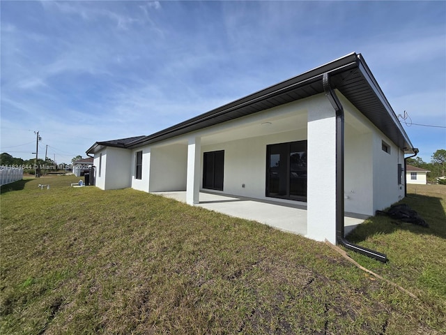 1605 W 11th St, Lehigh Acres, FL 33971 - rear view of house featuring a yard, a patio area, and stucco siding