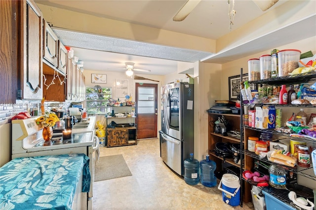 796 29th Ave, Vero Beach, FL 32968 - kitchen with stainless steel appliances, a ceiling fan, light flooring, and brown cabinetry