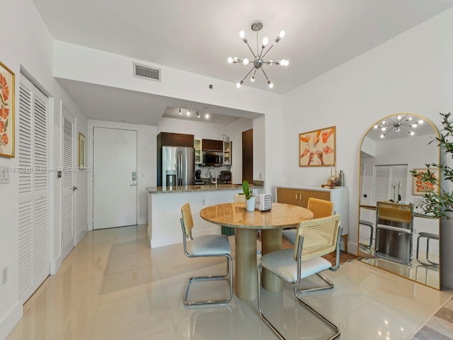 950 Brickell Bay Dr Unit 1103, Miami, FL 33131 - dining area with a chandelier, arched walkways, and light tile patterned floors