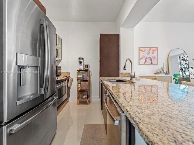 950 Brickell Bay Dr Unit 1103, Miami, FL 33131 - kitchen featuring stainless steel appliances, light stone counters, light tile patterned floors, and glass insert cabinets